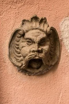 Stone head of a bearded man on an old building of the historical town Stock Photos