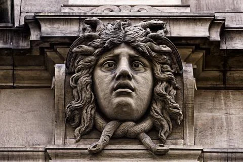 Stone head on a house facade Stock Photos