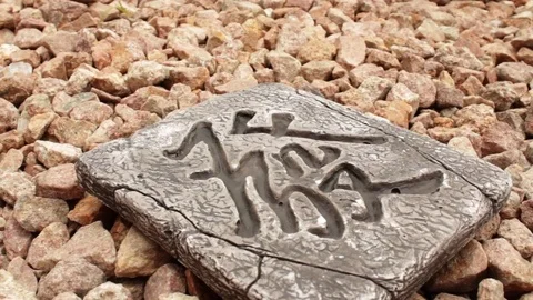 Stone hieroglyph on stones Stock Footage 77938895