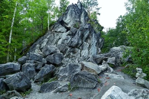 Stone hill among the trees Stock Photos