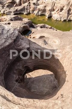 The stone hole caused by the water erode in Mekhong river after the water dro Stock Photos