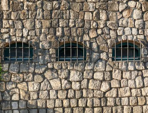 Stone house with bars on the windows Stock Photos