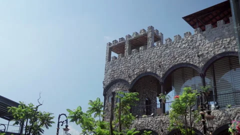 Stone interior wall of El Castillo del Tequila distillery with trees and offices Видео 346328080