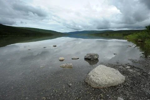 Stone in lake Stock Photos