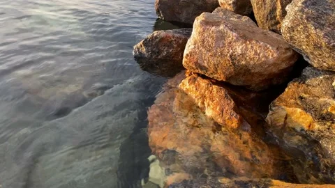 Stone in the lake, waves, evening Stock Footage 130140495