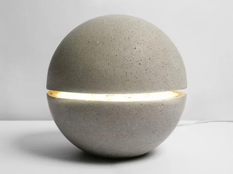 A stone lamp in the form of ball on the table. Stock Photos
