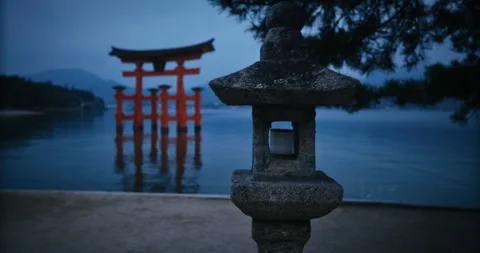 Stone Lantern and Red Torii Gate at Dusk Miyajima Japan Stock Footage 344700107