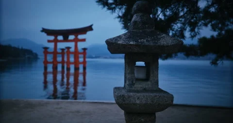 Stone Lantern and Red Torii Gate at Dusk Miyajima Japan Stock Footage 344700177