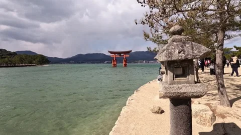 Stone Lantern and Torii Gate by Shore Stock Footage 311856304