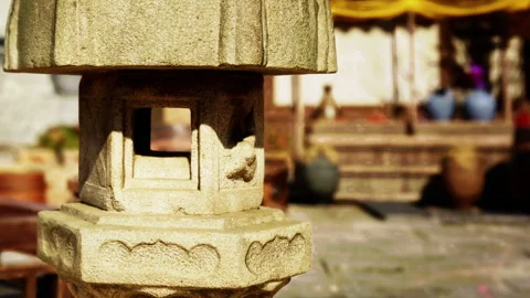 Stone lantern in a garden setting during daylight Stock Footage 344118325