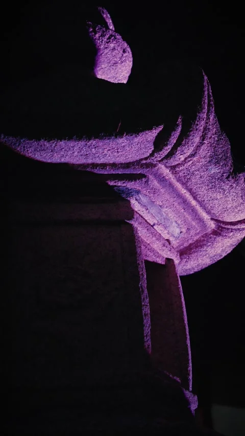 Stone lantern illuminated by purple light at night 库存影片 346264099