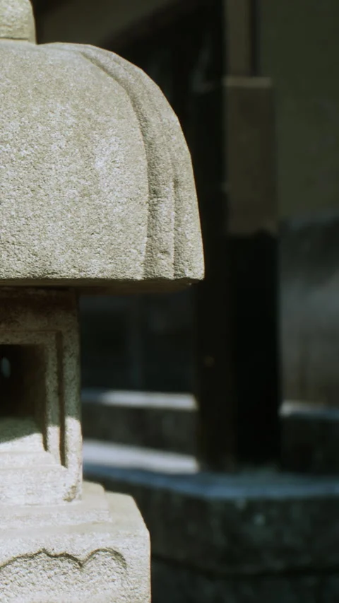 Stone lantern stands in a garden during daylight in a traditional setting Stock Footage 337973527