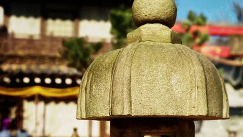 Stone lantern stands in a traditional Japanese garden under clear sky Video stock 344123687