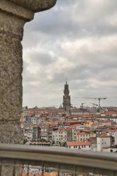 From a stone ledge, one looks out over the historic cityscape of Porto. Stock Photos