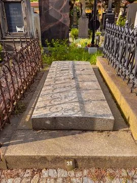 A stone ledger grave with a large raised relief cross Stock Photos