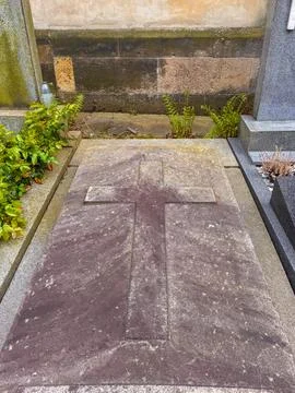 A stone ledger grave with a large raised relief cross Stock Photos