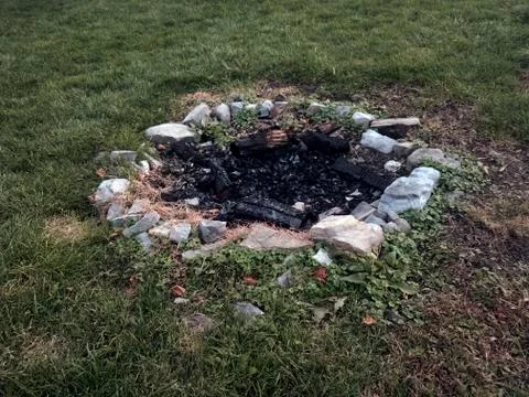 Stone lined camp fire ring Stock Photos