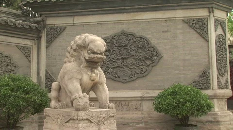 Stone Lion Statue Sits Outside the Taoist White Cloud Temple in Shanghai, China Stock Footage