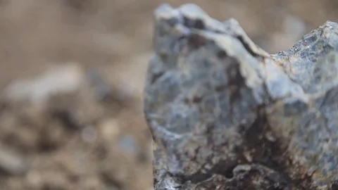 A stone lying on the ground. Shot through defocus Stock Footage 115325064
