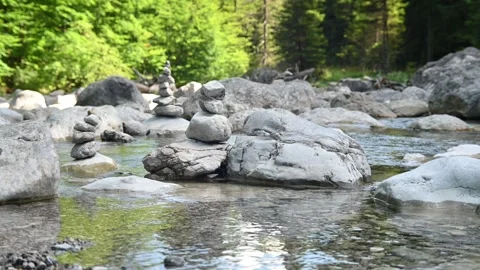 Stone man on a mountain stream river bed Stock Footage 260834357