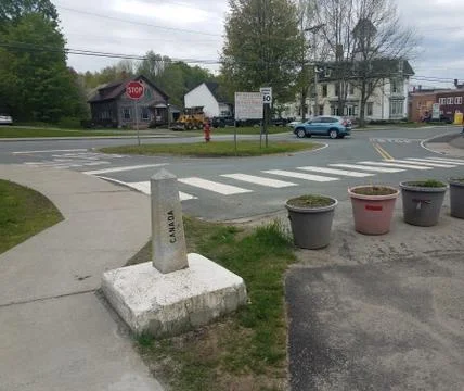 Stone marker on border of Canada and United States of America Stock Photos