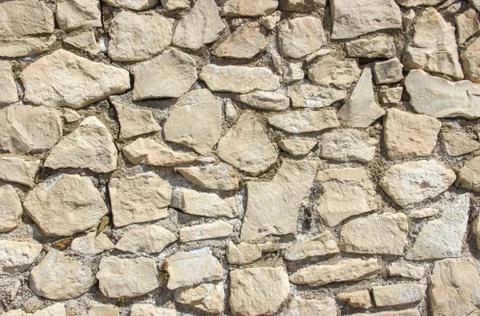 Stone masonry wall texture close up with clear yellow stones Stock Photos