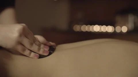 Stone massage back slow motion low light Stock Footage 68703836