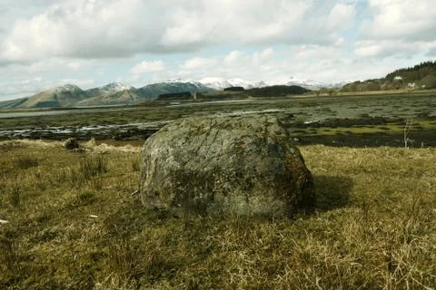 A stone in the middle of picture. Behind him incredible nature of scotland Stock Photos