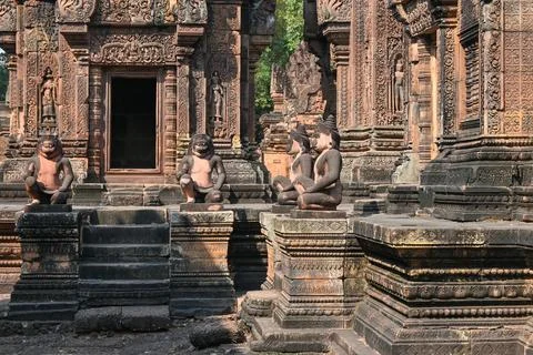 Stone monkey statues in front of a richly decorated ancient temple entrance Stock Photos