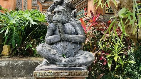 Stone monkeys statues in sacred monkey forest. Old decorative monkey sculpt.. Stock Photos