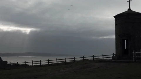 Stone monument on a cliff top Stock Footage 233985750