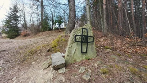 A stone monument of the Way of the Cross with a black metal cross 스톡 동영상 332156316