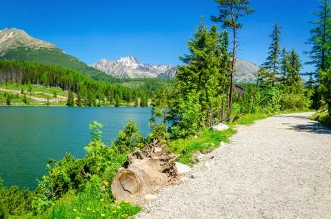 Stone mountain path in high mountains and lake Stock Photos