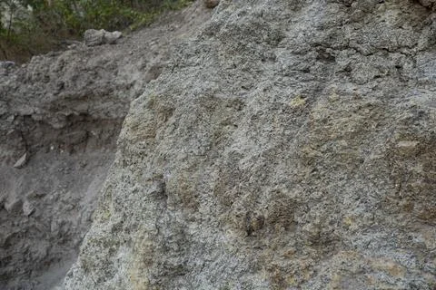 Stone mountain texture. A close up view of a steep stone quarry face showin.. Stock Photos