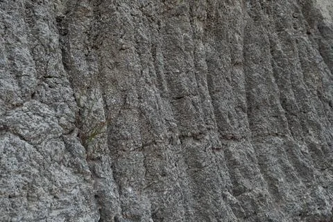 Stone mountain texture. A close up view of a steep stone quarry face showin.. Stock Photos