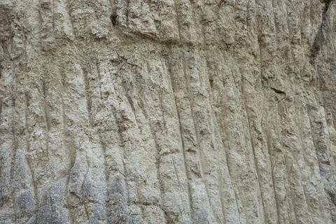 Stone mountain texture. A close up view of a steep stone quarry face showin.. Stock Photos