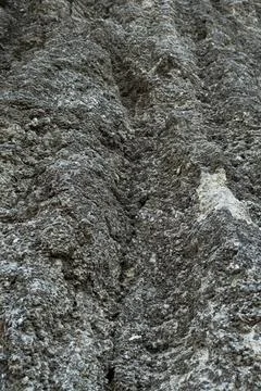 Stone mountain texture. A close up view of a steep stone quarry face showin.. Stock Photos