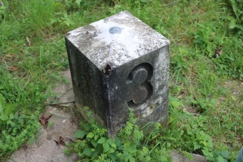 Stone with number in the grass Stock Photos