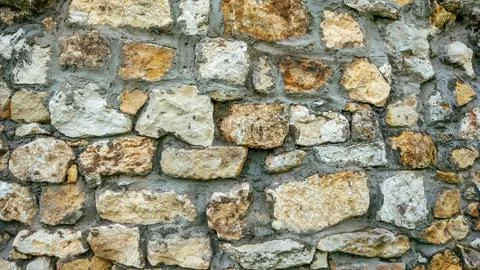 Stone old wall from huge blocks. Background of stones. The concept reliability Stock Photos