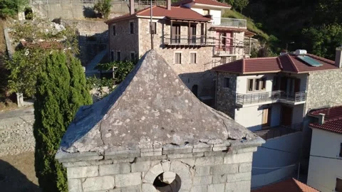 Stone Orthodox Bell Tower With Clock at Sunrise in Mountain Village Greece Video stock 324867576