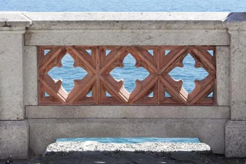 Stone parapet with flower pattern and sea views Stock Photos
