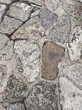 Stone path close-up with a pattern similar to footprints Fotos Stock