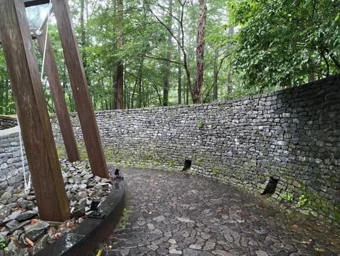 Stone path curves through forested greenery Stock Photos
