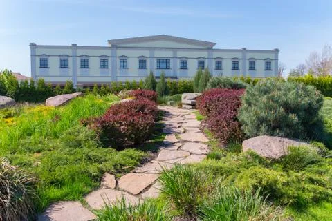 Stone path to a house on the background of a blue sky between beautiful decor Foto stock