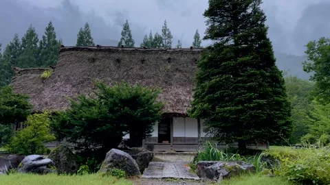 Stone Path Leading to Historic Gassho-zukuri House in Rainy Shirakawa-go Stock Footage 338187518