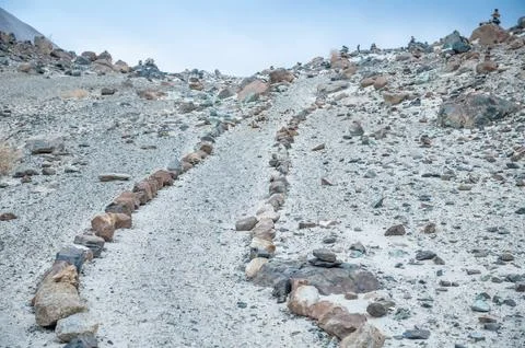 Stone path leading through the rugged Himalaya mountains, remote trekking trail  Stock Photos