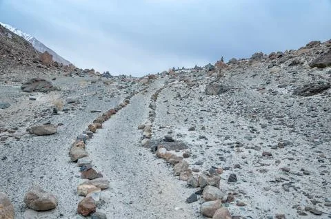 Stone path leading through the rugged Himalaya mountains, remote trekking trail  Stock Photos