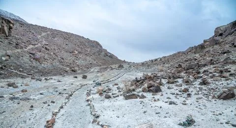 Stone path leading through the rugged Himalaya mountains, remote trekking trail  Stock Photos