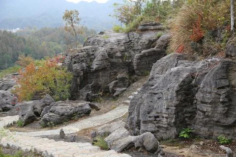 Stone path winding through layered rock formations Stock Photos