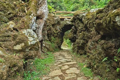 Stone paths passing through natural rocks and cliff. Stock Photos